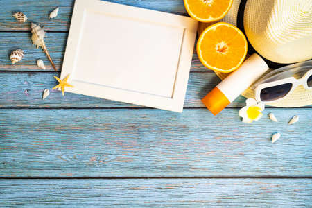Beautiful summer holiday, Beach accessories, orange, sunglasses, hat and sunblock on wooden backgroundsの写真素材