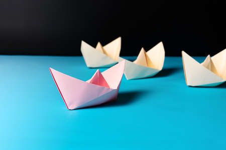 Leadership concept, pink paper ship lead yellow ship team memberの写真素材