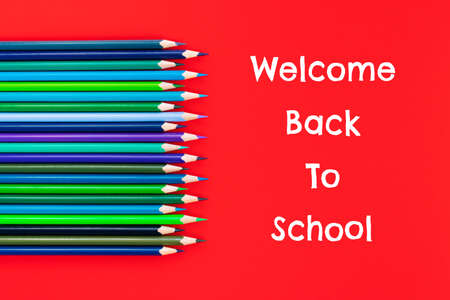 Welcome back to school background, colorful color pencil on red backgrounds with copy spaceの写真素材