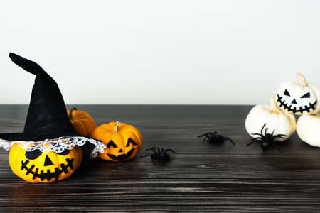 Happy Halloween, horror pumpkin and scary spider on wooden tableの写真素材