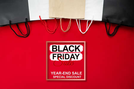 black friday sale, shopping bag on red backgroundの写真素材