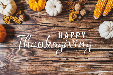 Happy Thanksgiving Day with pumpkin and nut on wooden table