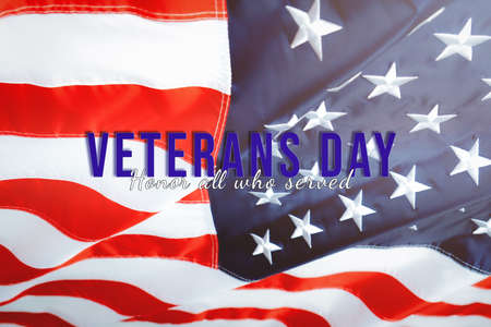 Veterans day. Honoring all who served. American flag waving in the wind.の写真素材