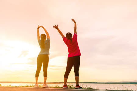 Sport women are stretching muscle before workoutの写真素材