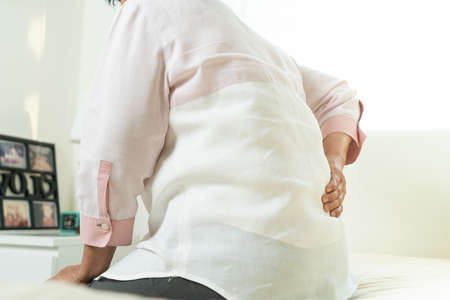 Back pain of old woman at homeの写真素材