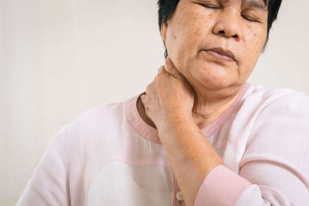 Neck and shoulder pain of old womanの写真素材