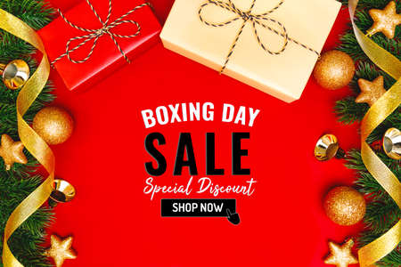 Boxing day sale with Christmas present and xmas decoration on red backgroundの写真素材