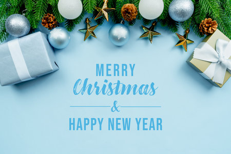 Christmas present and pine tree with xmas decoration on blue backgroundの写真素材
