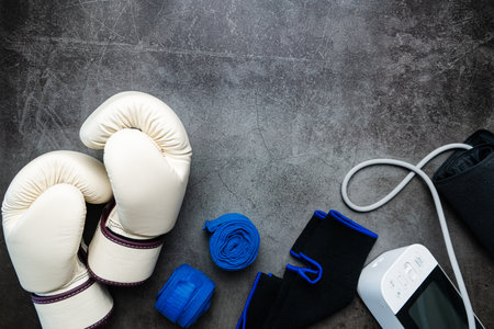 Boxing glove, sphygmomanometer, fitness equipment on a dark background with copy spaceの写真素材