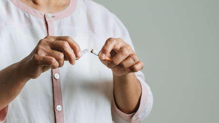 Quit smoking, no tobacco day, mother hands breaking the cigaretteの写真素材