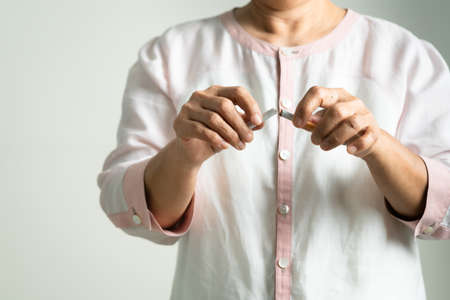 Quit smoking, no tobacco day, mother hands breaking the cigaretteの写真素材