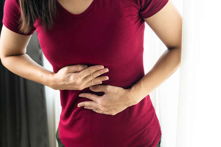 woman Suffering From Acid Reflux Or gastroesophageal reflux at homeの写真素材