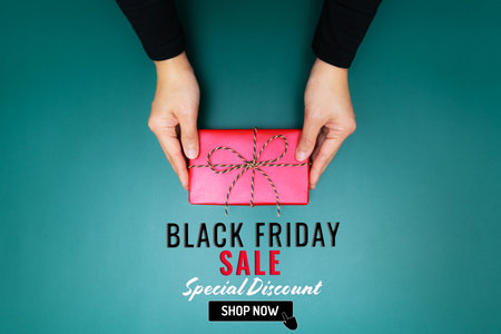 Black Friday Sale, young woman hand with a gift box offer to receiverの写真素材