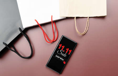 China 11.11 single day sale concept, smartphone with shopping bag.の写真素材