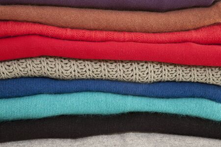 Close-up of Brightly Colored Sweaters Neatly Foldedの写真素材