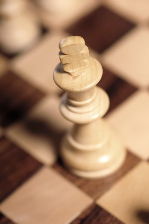 wooden chess pieces on a chessboard