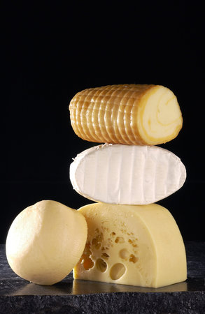 ripening and hard yellow cheeses on the background