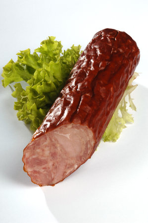 Krakowska dry sausage on a white background