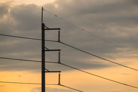 powerline pole on sunset backgroundの写真素材