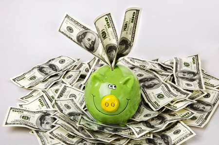 green piggy bank and dollarsの写真素材