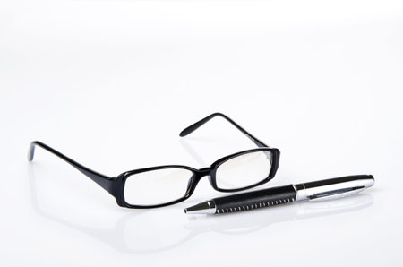 Black ballpoint pen and glasses