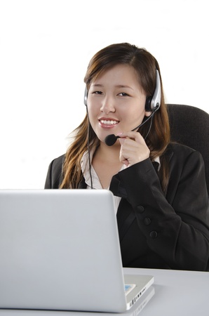 Confident female customer service agent with headsetの写真素材