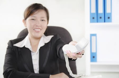 Businesswoman giving telephoneの写真素材