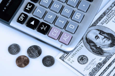 Calculator US coins and hundred dollars currencyの写真素材