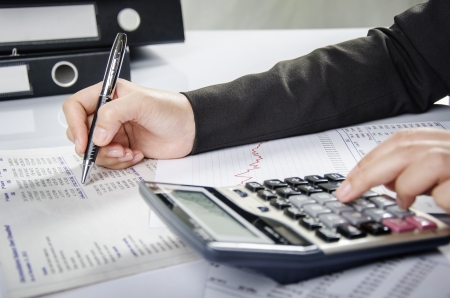 Business person working on financial reportの写真素材