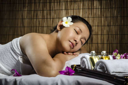 Portrait of fresh and beautiful woman laying on spa and massageの写真素材