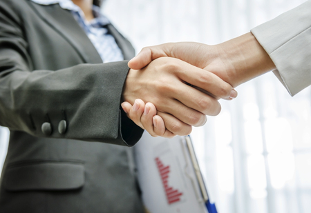 Business persons greeting by handshakingの写真素材