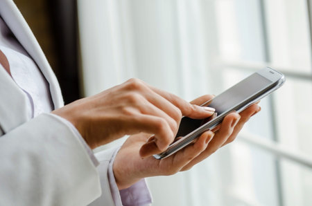 Closeup of woman hand touching smart phone