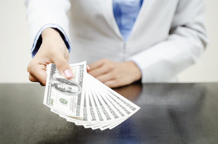 Money in hands of businesswomanの写真素材