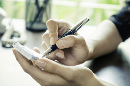 closeup of woman hands taking noteの写真素材