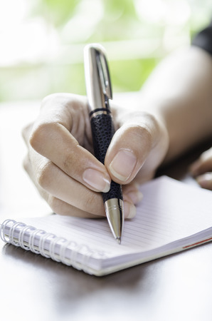 closeup of woman hands taking noteの写真素材