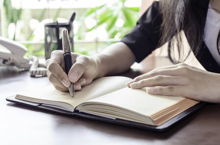 closeup of woman hands taking noteの写真素材