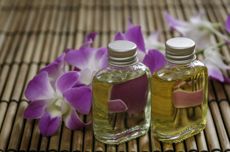 closeup of two essential oil and orchid flowerの写真素材