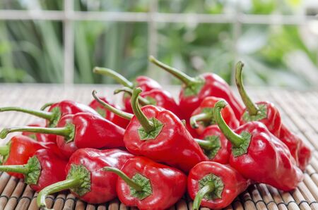 fresh red chilies on wooden bamboo displayの写真素材