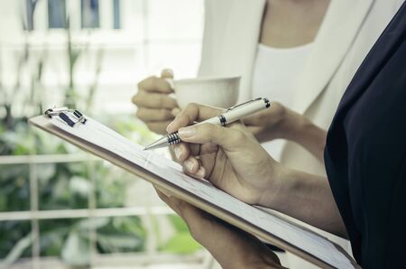 people discussing business during a tea breakの写真素材