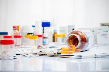 medicine capsules laid out on a folder medicine capsules laid out on a folder