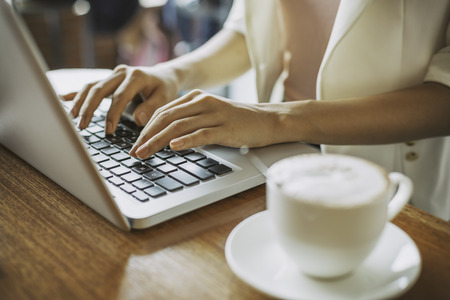woman working on a laptop in a coffee shopの写真素材