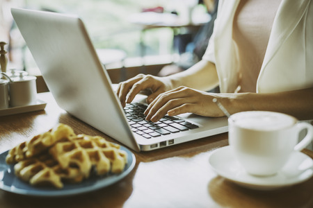 woman doing work in a coffee shopの写真素材