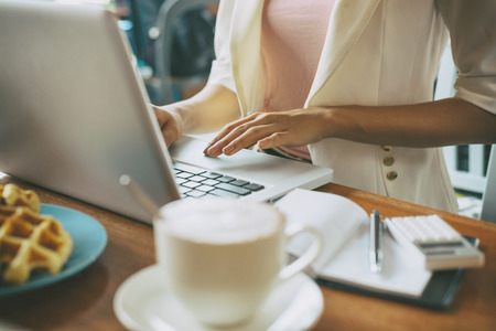 woman working on her laptop in a cafeの写真素材