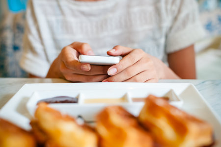 front view of woman using smart phone on the table