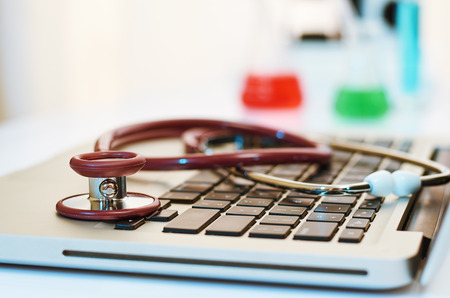 stethoscope on top of laptop in a labの写真素材