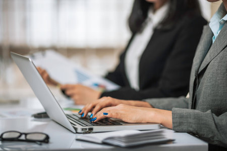 women employees typing on the laptop computer