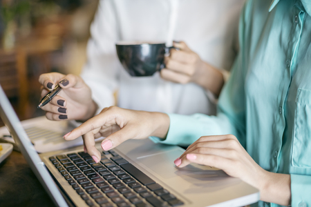 women discussing work at a coffee shopの写真素材