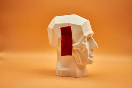 Plasterhead. Statue of a man on an orange background. Creative work of art. Plaster head. Statue of a man on an orange background. Creative work of art.の写真素材