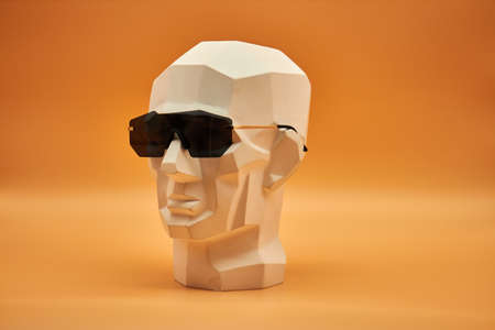 Plasterhead. Statue of a man on an orange background. Creative work of art. Plaster head. Statue of a man on an orange background. Creative work of art.の写真素材