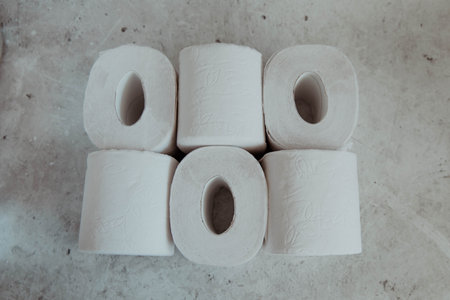 Stack of toilet paper rolls on a gray light background. high quality photoの写真素材
